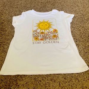 White T-shirt with a sun and flowers in the middle.